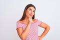 Portrait of beautiful young woman standing over isolated white background looking confident at the camera with smile with crossed Royalty Free Stock Photo