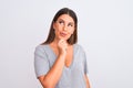 Portrait of beautiful young woman standing over isolated white background looking confident at the camera with smile with crossed Royalty Free Stock Photo