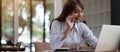 Portrait of a beautiful young woman studying while sitting at the table with laptop computer and notebook at home Royalty Free Stock Photo