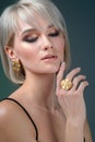 Portrait of a beautiful young woman in stylish. Stylish hairstyle and light makeup. Wearing earring and finger ring. Isolated on Royalty Free Stock Photo