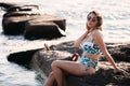 Portrait of beautiful young woman in sunglasses and bikini on beach. Female model posing in swimsuit on sea shore Royalty Free Stock Photo