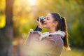 Portrait of beautiful young woman taking photos with vintage camera outdoors in the nature Royalty Free Stock Photo