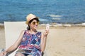 Portrait of beautiful young woman talking on the phone on the beach Royalty Free Stock Photo