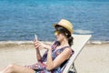 Portrait of beautiful young woman talking on the phone on the beach Royalty Free Stock Photo