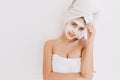 Portrait of beautiful young woman with towels after take bath make cosmetic mask on her face. Rejuvenation, cosmetology