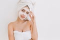 Portrait of beautiful young woman with towels after take bath make cosmetic mask on her face. Rejuvenation, cosmetology