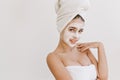 Portrait of beautiful young woman with towels after take bath make cosmetic mask her face. Rejuvenation,cosmetology