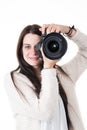 Beautiful young woman trainer photographer taking pictures in white background