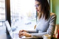 Beautiful young woman using her laptop in the coffee shop. Royalty Free Stock Photo