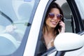 Beautiful young woman using her mobile phone in the car. Royalty Free Stock Photo