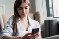 Portrait of beautiful young woman using her mobile phone at home Royalty Free Stock Photo