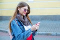 Portrait of beautiful young woman using her mobile phone in the park. Royalty Free Stock Photo