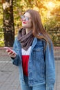 Portrait of beautiful young woman using her mobile phone in the park Royalty Free Stock Photo