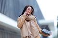 Beautiful young woman using her mobile phone in the street. Royalty Free Stock Photo