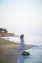 Portrait of beautiful young woman walks on coast of sea or ocean Royalty Free Stock Photo