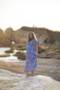 Portrait of beautiful young woman walks on coast of sea or ocean Royalty Free Stock Photo