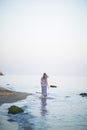 Portrait of beautiful young woman walks on coast of sea or ocean Royalty Free Stock Photo