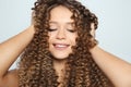 Portrait of beautiful young woman with wavy hair on color background, closeup Royalty Free Stock Photo
