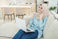 Beautiful young woman wearing hijab watching great movies on lap Royalty Free Stock Photo