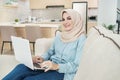 Beautiful young woman wearing hijab working on laptop Royalty Free Stock Photo