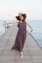 Portrait of beautiful young woman wearing wide straw hat and lon Royalty Free Stock Photo