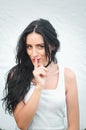 Portrait of a beautiful young woman in a white T-shirt with black hair. joy and laughter degenerate. positive emotions. Life style Royalty Free Stock Photo