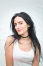 Portrait of a beautiful young woman in a white T-shirt with black hair. joy and laughter degenerate. positive emotions. Life style