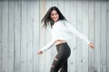 Portrait of a beautiful young woman in a white T-shirt with black hair. joy and laughter degenerate. positive emotions. Life style