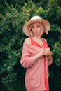 Portrait of beautiful young woman in wide beach hat, against background of summer green park Royalty Free Stock Photo