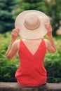 Portrait of beautiful young woman in wide beach hat, against background of summer green park Royalty Free Stock Photo