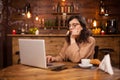 Portrait of beautiful young woman working on her laptop in a coffee shop Royalty Free Stock Photo