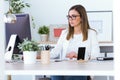 Beautiful young woman working with her laptop in the office. Royalty Free Stock Photo