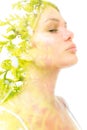 A double exposure portrait of a beautiful woman& x27;s profile with her eyes closed combined with a photo of green foliage Royalty Free Stock Photo