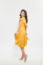 Portrait of a beautiful young woman in yellow dress and turn around Royalty Free Stock Photo