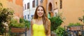 Portrait of beautiful young woman in yellow summer dress walking and exploring Trastevere neighborhood in Rome, Italy. Panoramic Royalty Free Stock Photo