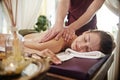 Smiling Young Woman Enjoying Massage in SPA Royalty Free Stock Photo