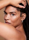 Portrait, beauty and black woman skincare, face and natural makeup cosmetics in brown studio background. Gen z model