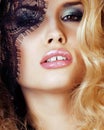 Portrait of beauty blond young woman through black lace close up Royalty Free Stock Photo