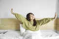 Portrait of beauty happy Asian woman awaking, wake up on the bed (sleep). Royalty Free Stock Photo