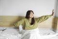 Portrait of beauty happy Asian woman awaking, wake up on the bed (sleep). Royalty Free Stock Photo