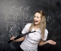 Portrait of beauty happy student with books near blackboard Royalty Free Stock Photo