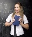 Portrait of beauty happy student with books near blackboard Royalty Free Stock Photo