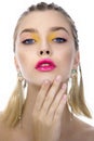 Portrait of beauty model with yellow creative makeup and vivid pink glossy lips, isolated on white. Beautiful young woman with Royalty Free Stock Photo