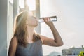 Portrait of Beauty Red-haired woman with eye patches drinks water. Spa Girl Royalty Free Stock Photo