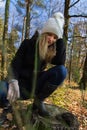 Portrait of beauty sadness young woman in white cap in forest