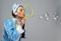 Portrait of beauty snow maiden blowing bubble