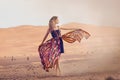 Portrait of a beauty woman in a dress in the hot desert