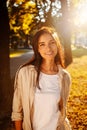 Portrait of beauty woman Enjoying Nature Outdoors. Beautiful autumn model with long hair. Sunlight at sunset. Warm toned artwork. Royalty Free Stock Photo