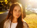 Portrait of beauty woman Enjoying Nature Outdoors. Beautiful autumn model with long hair. Sunlight at sunset. Warm toned artwork. Royalty Free Stock Photo