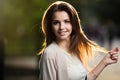 Portrait of beauty woman with perfect smile walking on the street and looking at camera, sunset light Royalty Free Stock Photo